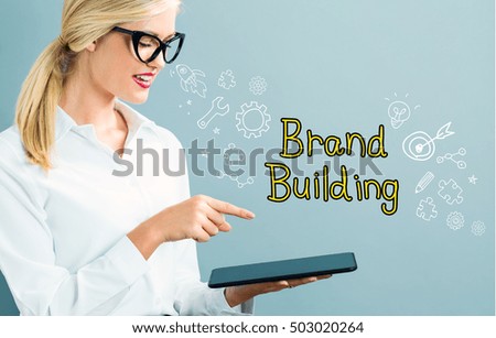 Brand Building text with business woman using a tablet
