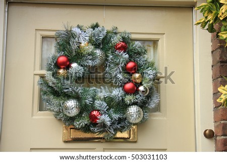 Classic christmas wreath with decorations on a wooden door