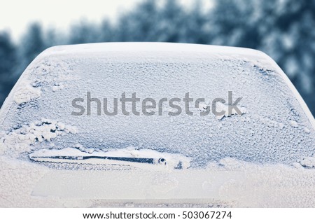 Winter frozen back car window, texture freezing ice glass background Royalty-Free Stock Photo #503067274