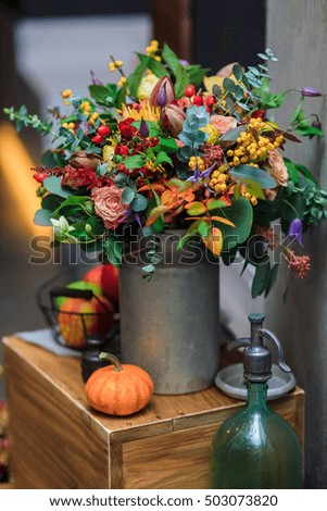 Autumn in the interior composition of flowers, gourds, wooden boxes