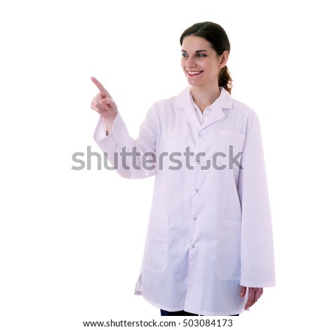 Smiling female doctor assistant scientist in white coat over white isolated background pointing, showing direction or pushing button, healthcare, profession, science and medicine concept