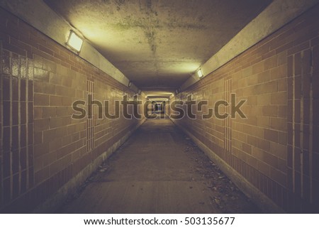 Empty underpass tunnel at night with light