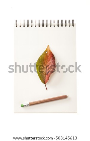 A empty(blank) white note with yellow(red, green, brown) leaf(leaves), pencil, ring for fall(autumn) isolated white.