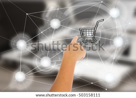 Mobile shopping concept - hand pointing on cart