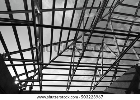 Black and white photo,Structure of steel roof frame for building construction.