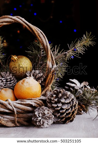 Christmas card decoration with fir branches, tangerines, pine cones, and decoration elements , selective focus
