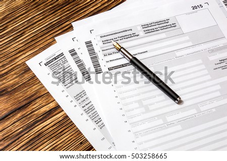 Pen on German tax form. Translation:(income tax return, capital income, employee's savings, loss carryforward, tax number, tax office, change of residence, General Information, Taxable person)
