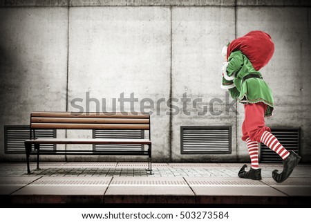 christmas time and photo of xmas elf on subway station and gray old wall for your decoration 