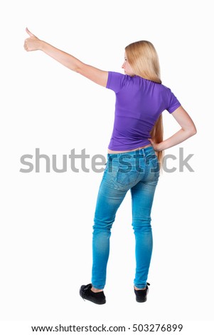 Back view of  pointing woman. beautiful girl. Rear view people collection.  backside view of person.  Isolated over white background. Long-haired blonde in the purple shirt is pointing sideways.