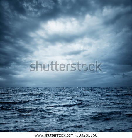 Stormy Sea and Sky. Thundery Clouds and Gray Ocean. Wild Nature Dark Dramatic Background. Toned and Filtered Square Photo with Copy Space.