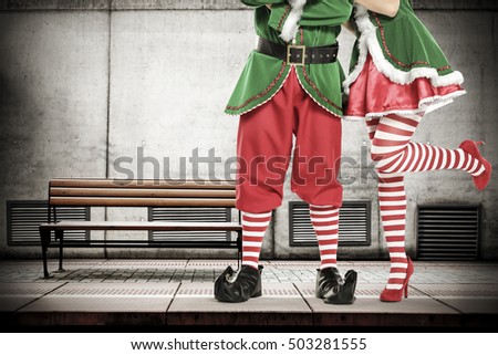 green young elf on subway station and big gray wall for your decoration of christmas text 