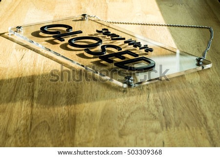 Acrylic sign with message "Sorry, we're closed" which placing