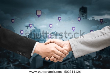 Handshake with map of the world in background