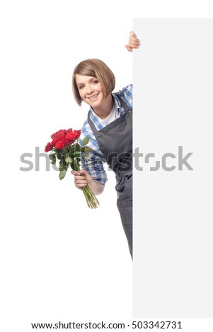 professional florist holding rose flowers and peeking from behind banner with empty copy space isolated on white background. business and floristry concept. advertisement blank board. your text here