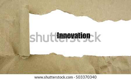 Torn brown paper on white surface with "innovation" word.