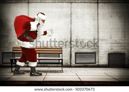 red santa claus on subway station and big wall of free space for your decoration 