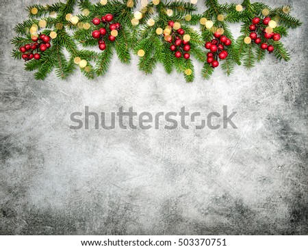 Christmas decoration with red berries and golden lights. Vintage style dark toned picture