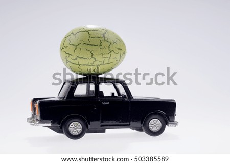 Big green easter egg on the black car