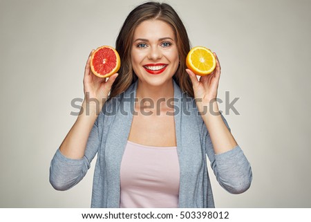 smiling woman holding half orange and grapefruit. isolated studio portrait.