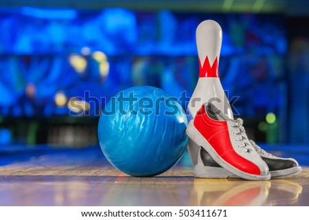 bowling shoes and ball for bowling game on the background of the playing field, copy space 