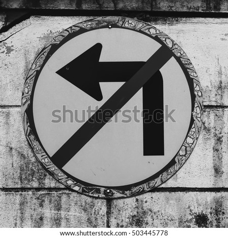 Do not turn left traffic sign on black and white