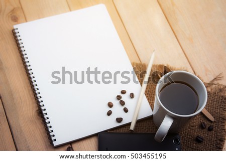 A glass of black coffee with blank space on notebook page, background for creative wording work
