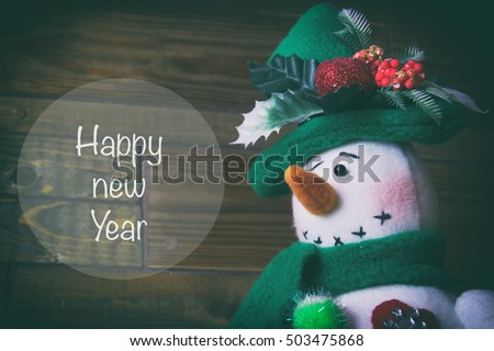 Christmas snowman on a wooden background, New Years toys