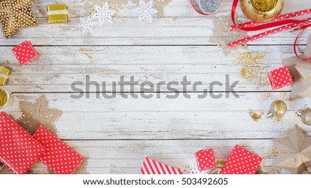 White wooden christmas background with gold and silver decorations red gift boxes and ribbons. Empty mock-up with text space.