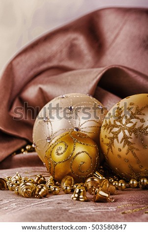 Festive gold Christmas decorations on a fabric background HDR Filter.