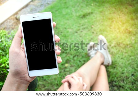 woman using smart phone in garden