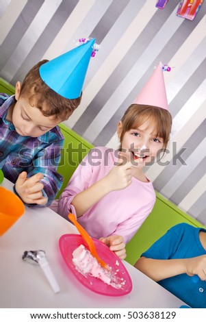 Kids on birthday party opening presents.
Selective focus 