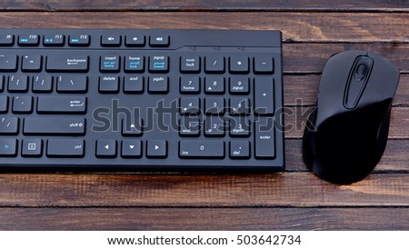 Keyboard computer with mouse on wooden table Royalty-Free Stock Photo #503642734