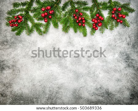 Christmas tree branches with red berries. Holidays decoration. Vintage style toned picture