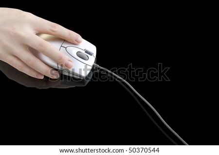 computer mouse in  hand on the black