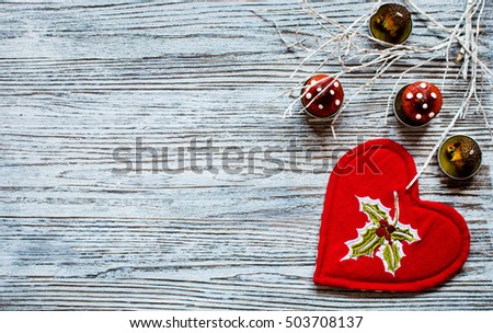 Red heart with candle copyspace for Valentines or Christmas on wooden background