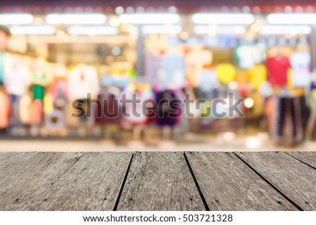 Look out from the table, blur image of  clothes shop as background.