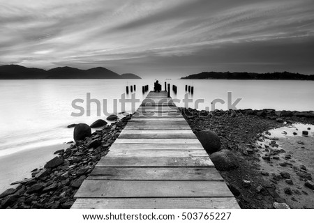 Beautiful seascape view with wooden jetty at Marina Island, Lumut Perak Malaysia. Black and white photography.