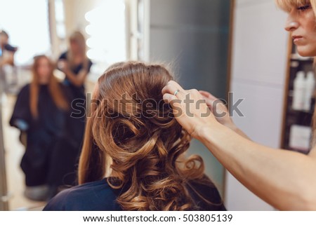 Hair stylist makes the bride before wedding Royalty-Free Stock Photo #503805139