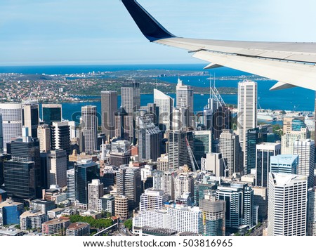 Airplane flying over Sydney. Tourism concept.
