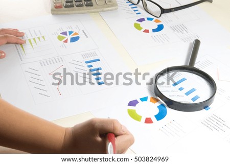 Data analyzing in trading market with pen. Working set for analyzing financial statistics and analyzing a market data. Data analyzing from charts and graph to find out the result. - Vintage tone.