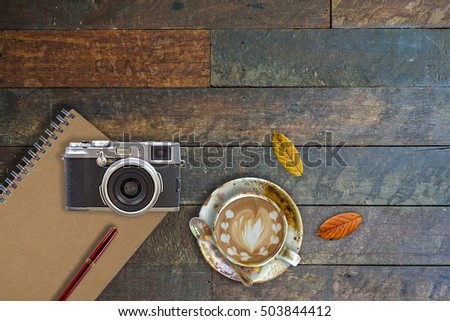 Workspace on rustic wood desk table of a hipster photographer.top view