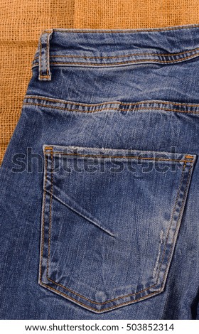 Jeans texture with leather label. on light natural linen texture,