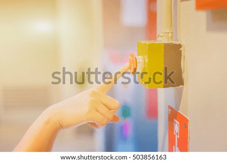 Emergency button on machine in factory by man hand,selective focus vintage color