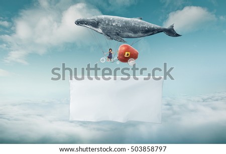 Whale floats in the sky with a happy sister  and carrying a blank white banner with a copy space area.