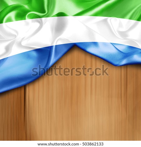 Sierra Leone Country Flag on Wood background
