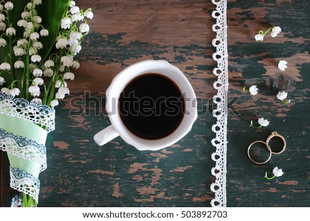 bouquet of lilies of the valley and morning coffee