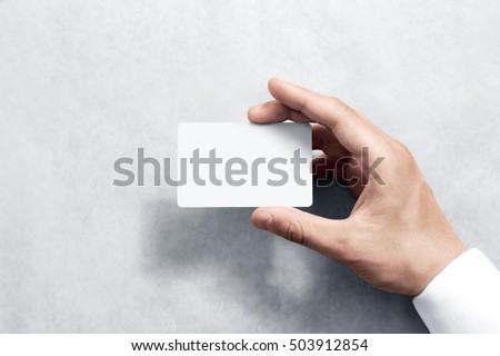 Hand hold blank white card mockup with rounded corners. Plain call-card mock up template holding arm. Plastic credit namecard display front. Check offset card design. Business branding. Royalty-Free Stock Photo #503912854