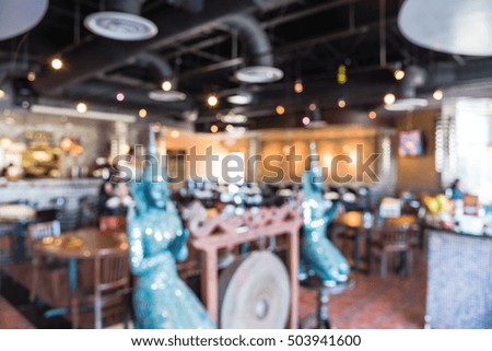 Blurred image interior of a Thai restaurant in Houston, Texas, US. Abstract blur Buddha restaurant for background. Unidentified customers enjoy fresh and traditional authentic Thailand food.