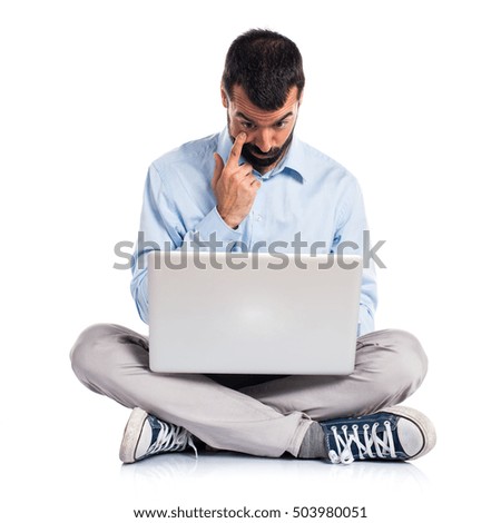 Man with laptop showing something