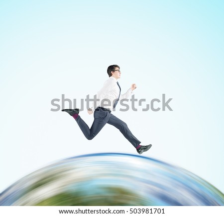 Side view of businessman in glasses running on huge globe. Concept of international business. Mock up. Elements of this image furnished by NASA